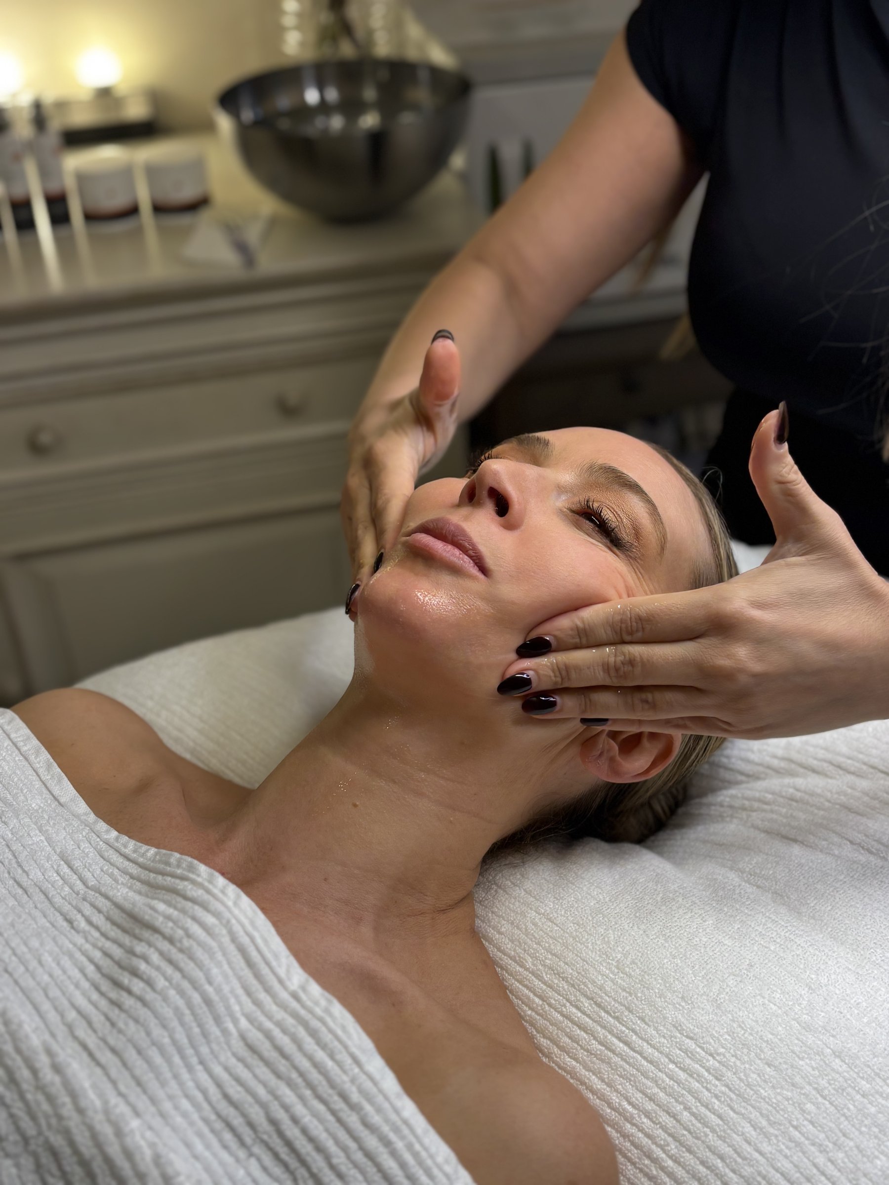 Maryam performing a facial treatment on a client at Skin Glow By Maryam